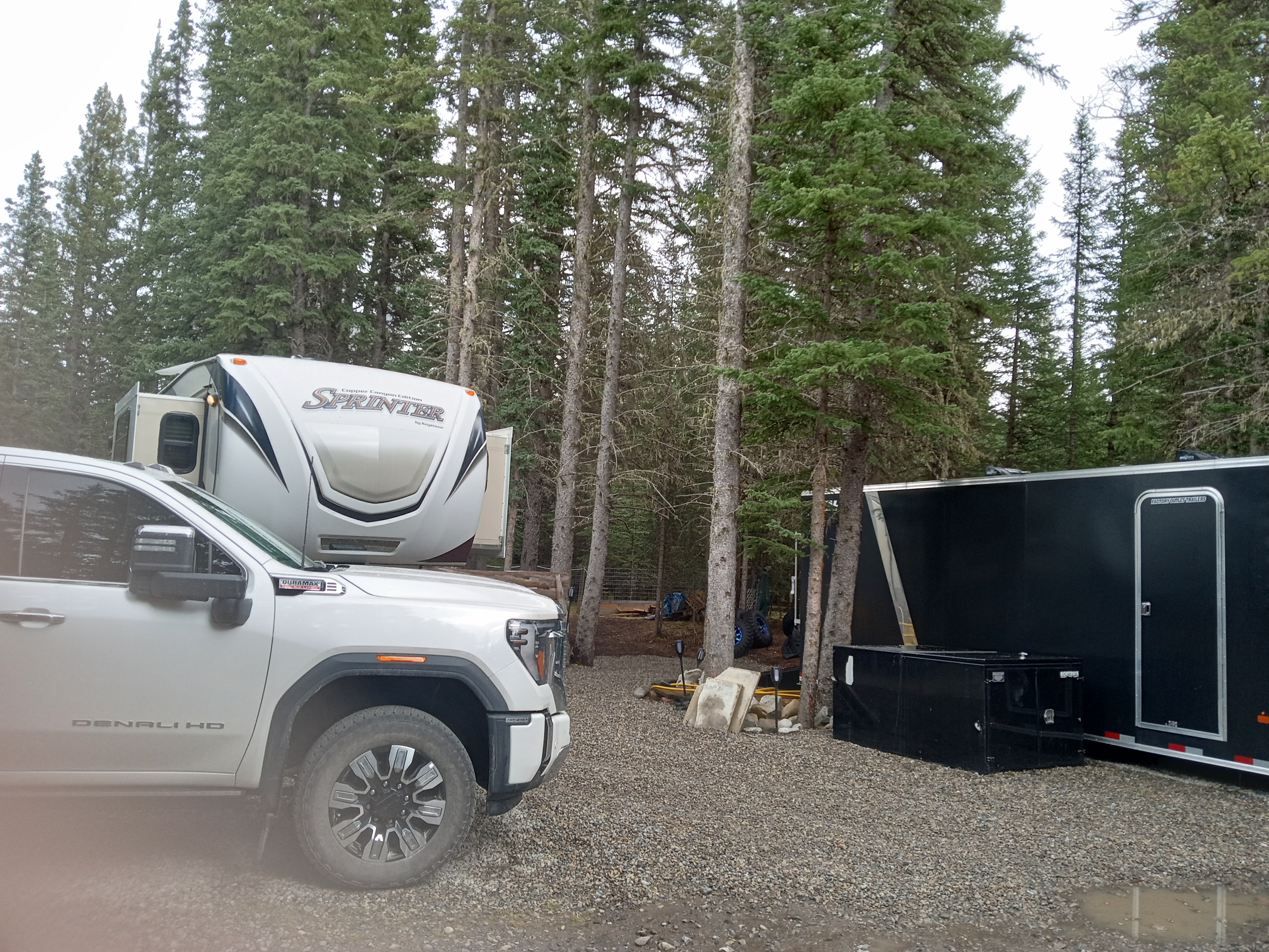 RV and truck parked among the trees at Barrier Mountain Outfitters campground